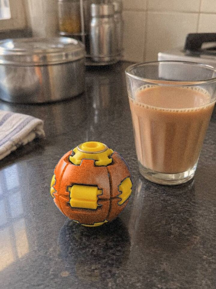 OrbitPop next to a glass of chai